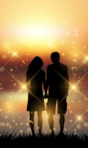 Silhouette of a couple holding hands against a sunset sky